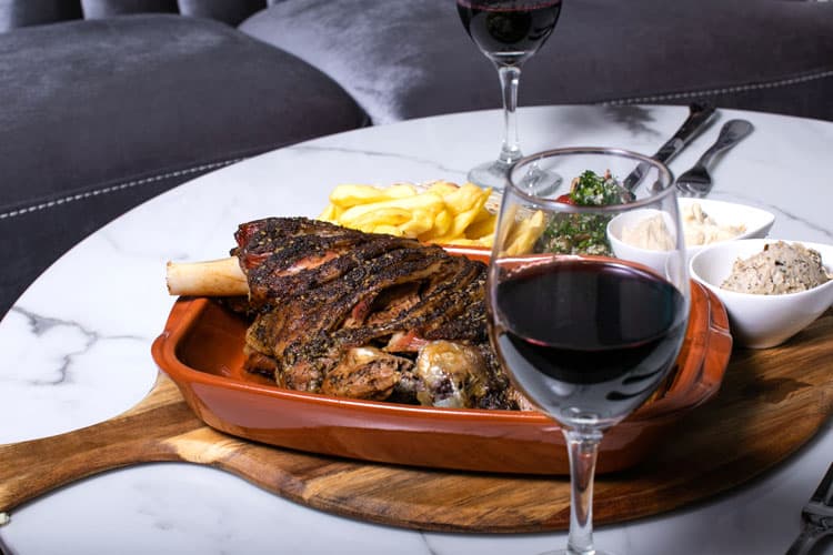 Za'atar lamb with chips, tabbouleh and a glass of red