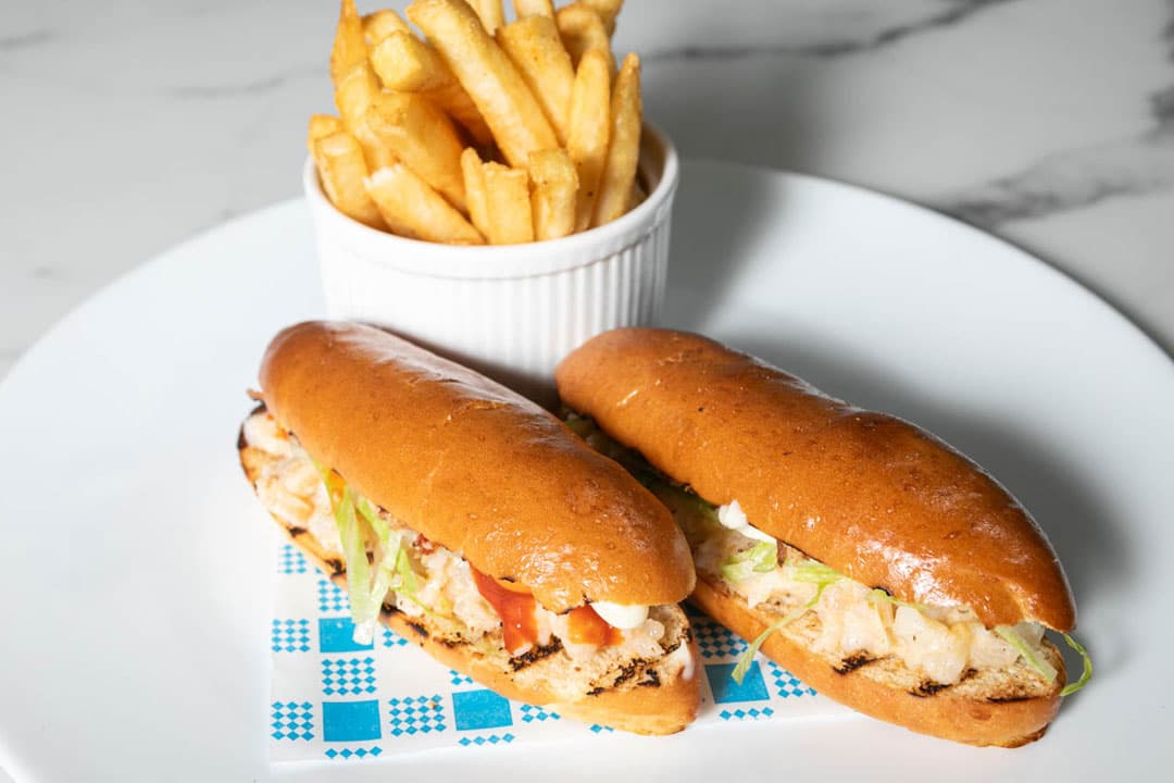 Two seafood rolls served with a cup of fries