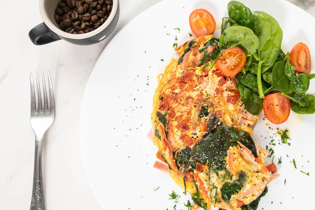 Seafood frittata with a spinach and tomato salad