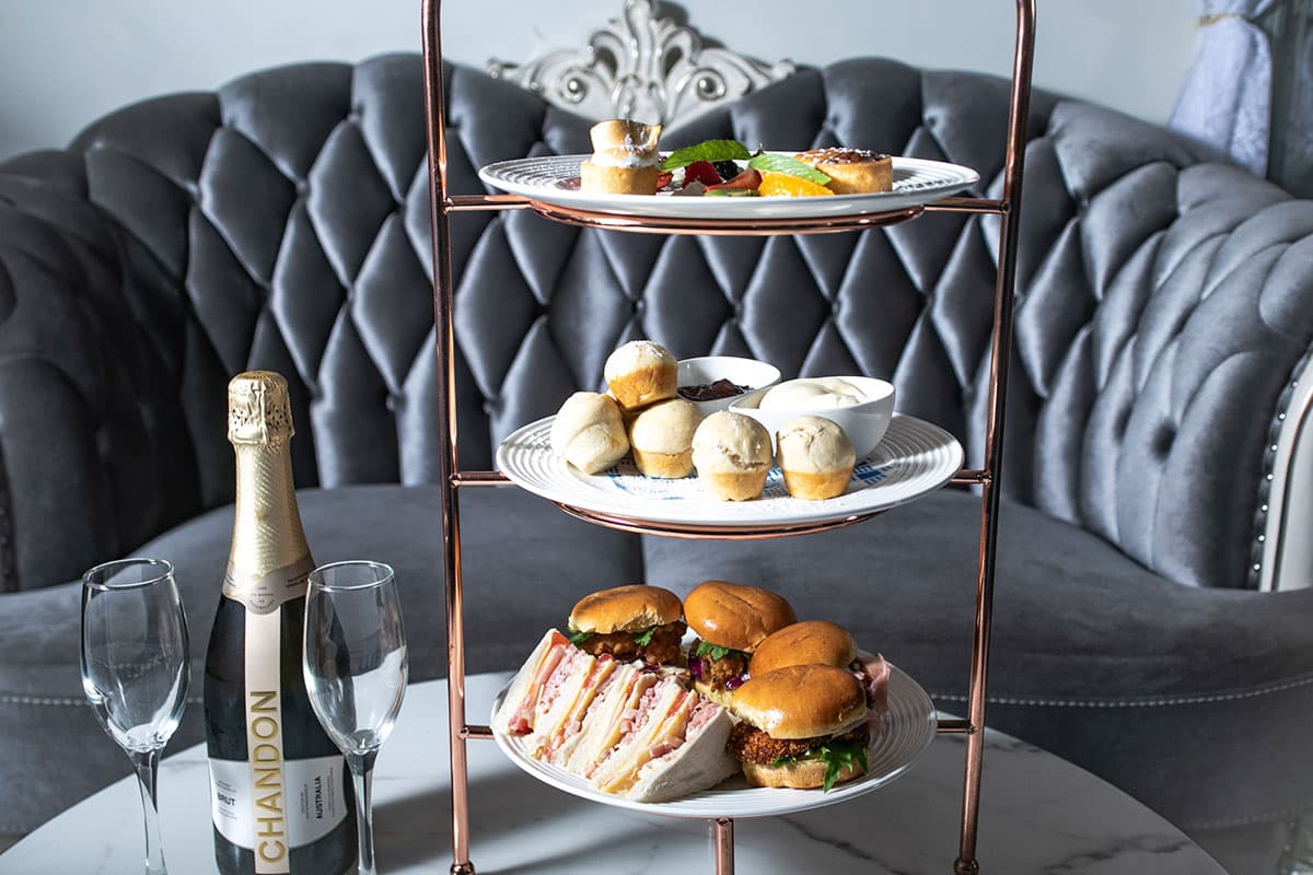 The three-tier high tea stand with sparkling wine